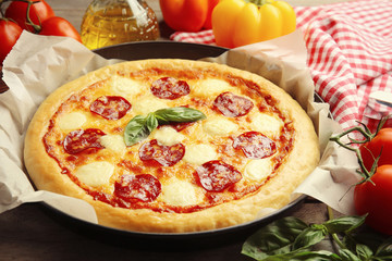 Homemade pepperoni pizza on wooden table