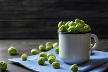 Brussels sprouts in metal mug on table