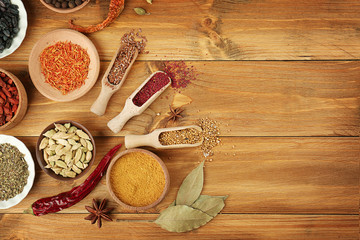 Aromatic spices on wooden background