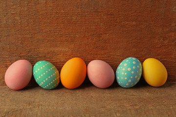 Colorful Easter eggs on wooden background