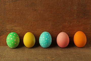 Colorful Easter eggs on wooden background