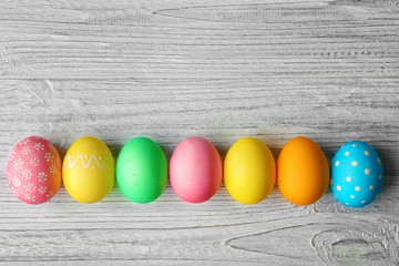 Colorful Easter eggs on wooden table