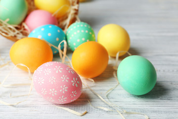 Fototapeta na wymiar Colorful Easter eggs on wooden table, closeup