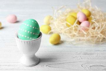 Closeup of painted Easter egg on wooden background