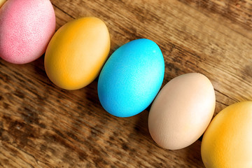 Colourful Easter eggs on wooden background