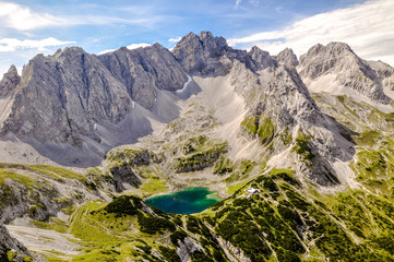 Panorama view of Drachensee lake with the mountains Gruenstein and Vorderer Drachenkopf in the state of Tirol / Tyrol in Austria.The lake with its cabin is a popular hiking destination for tourists.