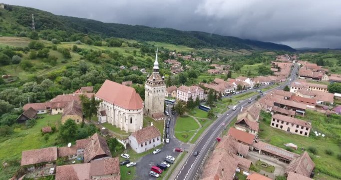 Fortified Saxon village Saschiz in the heart of Transylvania. Aerial footage from a 4K drone.