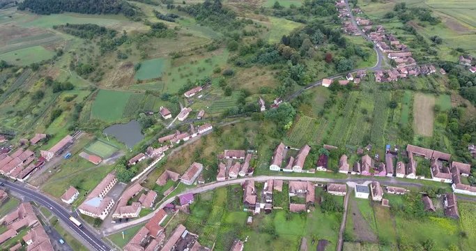 Fortified Saxon village Saschiz in the heart of Transylvania. Aerial footage from a 4K drone.