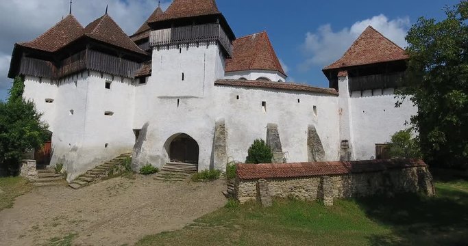 Viscri fortified church in the german Saxon village of Viscri in Transylvania. Aerial view from a drone