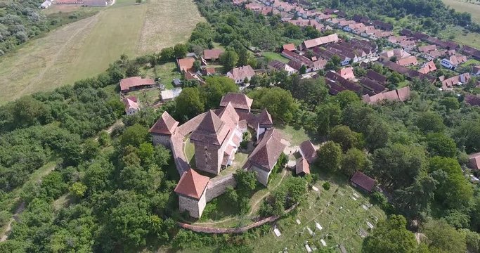 Viscri fortified church in the german Saxon village of Viscri in Transylvania. Aerial view from a drone