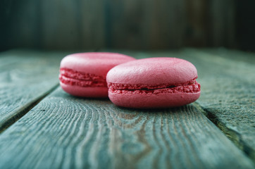 Close up macarons on rustic wooden table