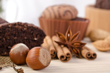 Obraz na płótnie Canvas chocolate cake with nuts and cinnamon stick, star anise
