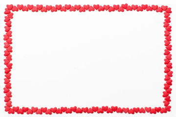 frame of small red hearts on a white background. Festive background for Valentine's day, birthday, wedding, holiday, postcard, party