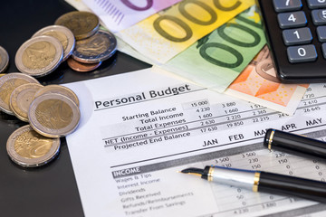 Financial report with euro money, pen on table.