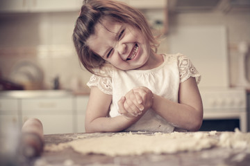 Fototapeta premium Portrait of girl in kitchen.
