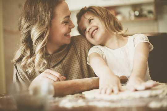 Mother And Daughter Baking Cookies.