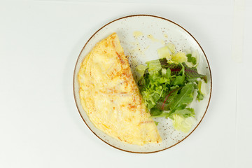 omelette with salad on white background