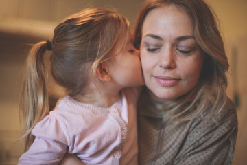 Daughter kissing her mother.