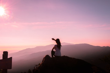 The silhouette of a woman Happy mountain morning sunrise.