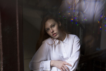 Tender young model with freckles in the shadows