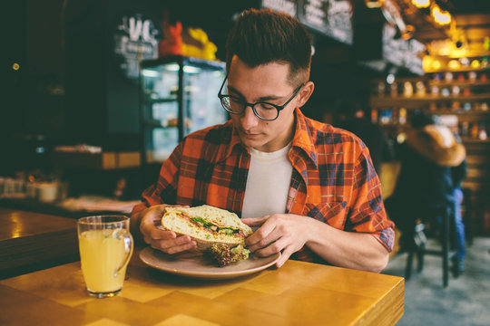 Man Eating In A Restaurant And Enjoying Delicious Food