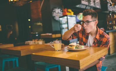 Fototapeta premium Man is eating in a restaurant and enjoying delicious food