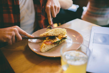 Obraz na płótnie Canvas Man eating in a restaurant and enjoying delicious food
