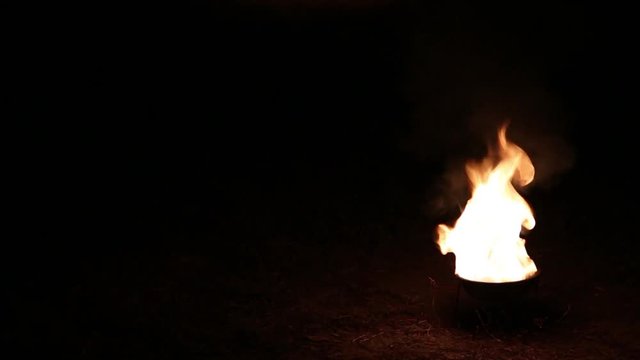 Flame of fire isolated on black background outside at night time. Real time full hd video footage