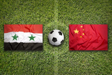 Syria vs. China flags on soccer field