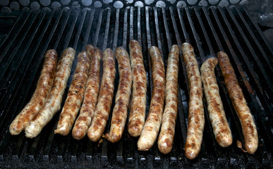 Cooking sausages on the grill in the restaurant