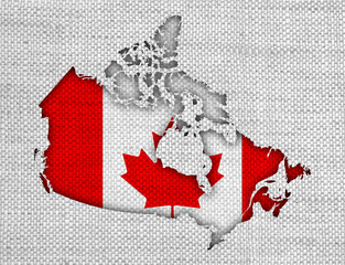 Karte und Fahne von Kanada auf altem Leinen