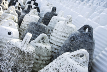 Marine themes, white buoys on the shore in the winter. Close up