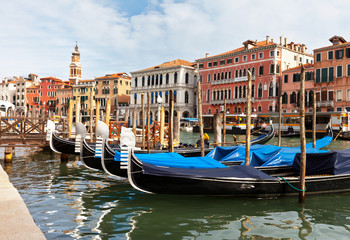 Obraz na płótnie Canvas Venetian gondolas on the Grand Canal near the Rialto Bridge