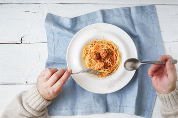 Eating spaghetti with meatball top view