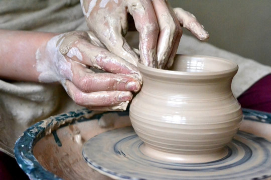 potter making vase from clay