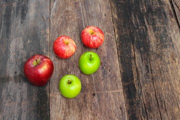 red and green apple on wooden background