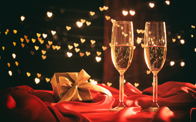 Champagne glasses on hearts bokeh background © Rawf8