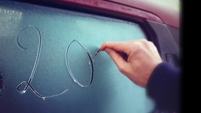 Year Number 2017 Written On Frosty Car Window By A Finger