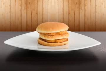 chicken hamburger in white plate , on top table