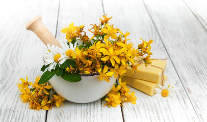 Tutsan flowers  and mortar with soap