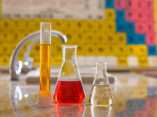 Laboratory flasks containing colored solutions