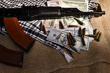 Combat weapons, US dollars and ammunition scattered
