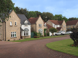 English suburban street with well maintained middle class stone houses with gables