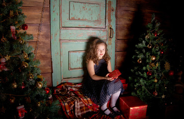 Happy little girl  decorate Christmas tree
