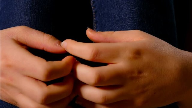 Stressed hands of a young woman, close up