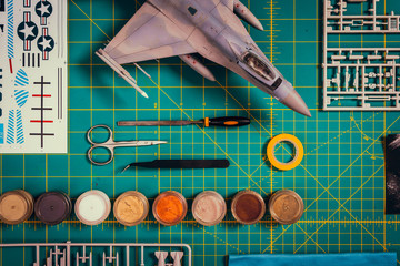 view from the top of paint, tools and plastic scale model
