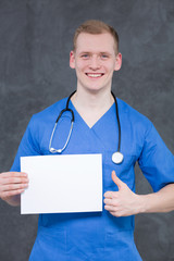 Happy doctor with white piece of paper