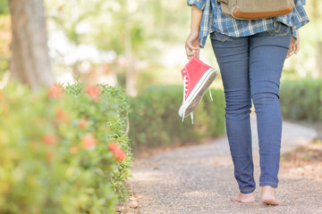 Barefoot woman walking on the pathway