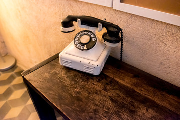 Vintage phone on old wooden table 