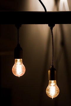 Bulbs hanging from a current thread in a dark room , creates a magical atmosphere